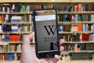 Cellphone browser of wikipeedia in front of library